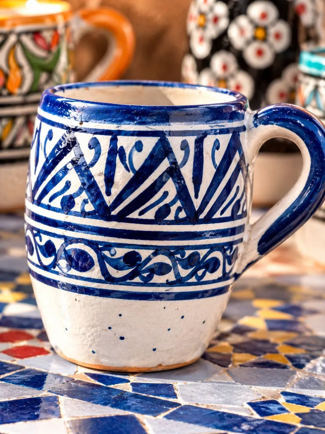 Close-up of a blue and white hand-painted Moroccan ceramic mug made in Fez, Morocco.