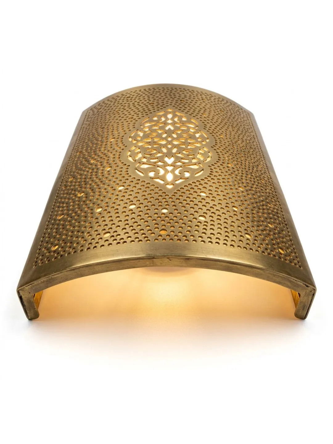 Underside view of a curved Moroccan brass wall sconce showing its perforated shade, decorative cutout pattern, and open lower edge.