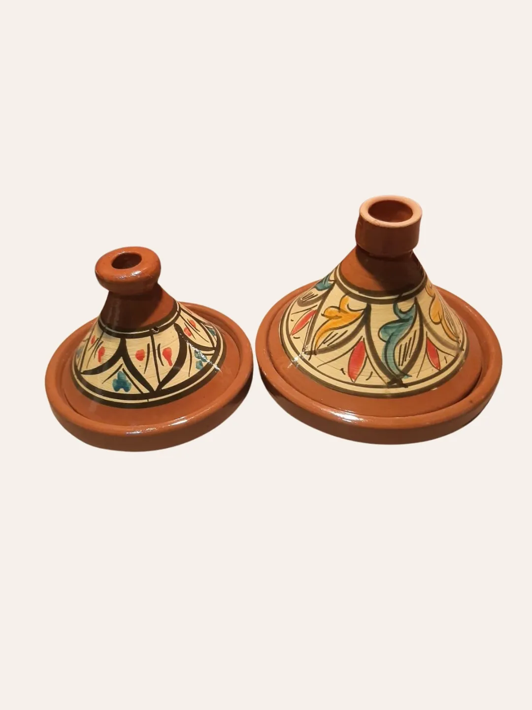 Moroccan ceramic tagines shown in two different sizes with painted decorative patterns