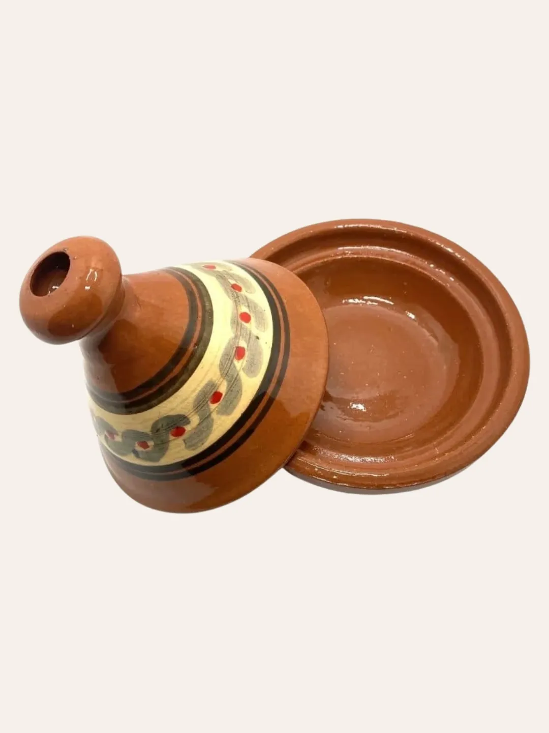 Moroccan ceramic tagine shown from above with decorated lid and serving base